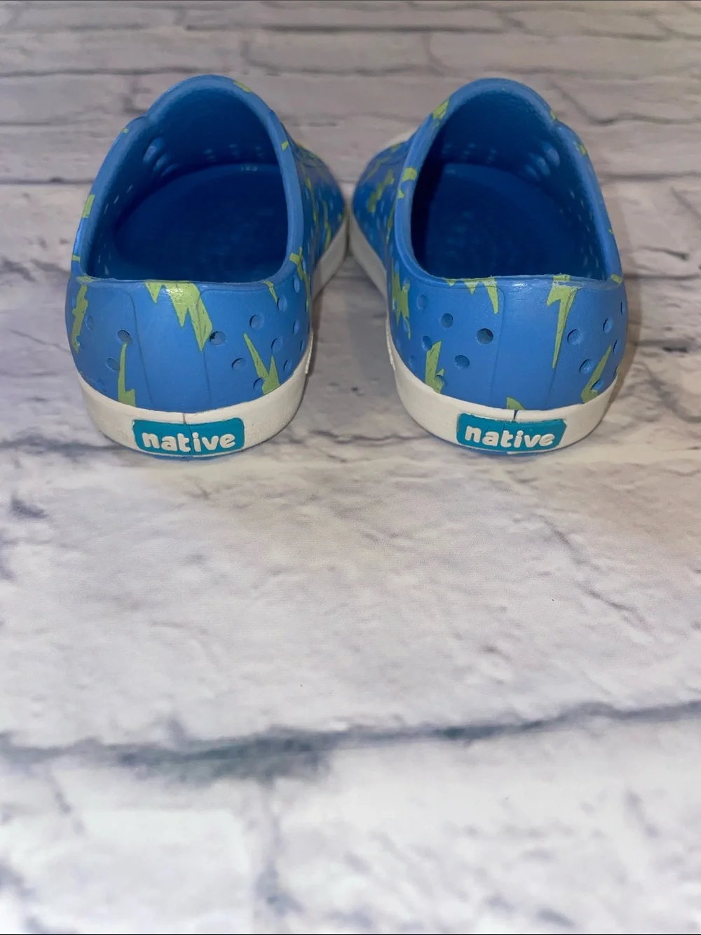 Native Jefferson Blue Slip-On with Neon Lightning Bolts. Size 5